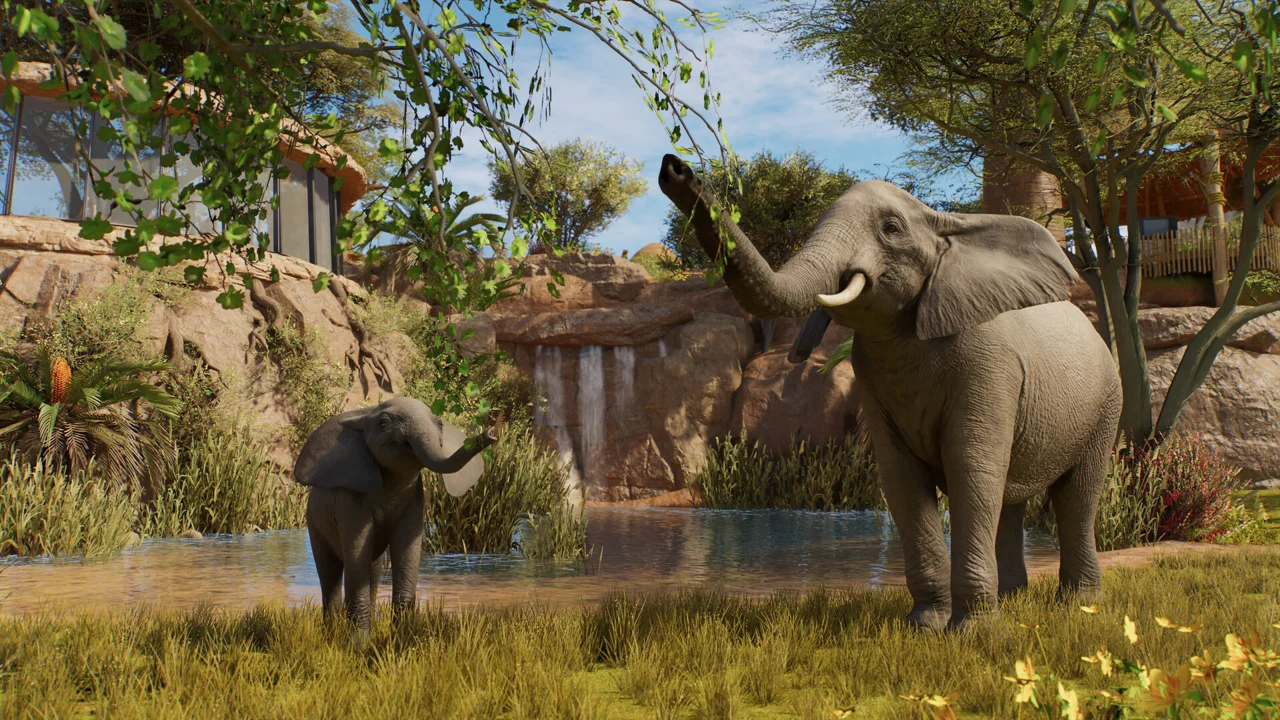 Adult and young elephants in a lush landscaped habitat
